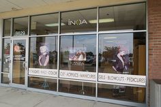 the front window of an upscale manicure store with advertisement on it's windows