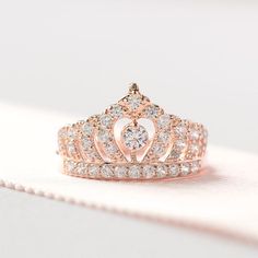 a princess's tiara ring is shown on top of a piece of cloth