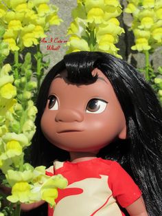 a close up of a doll with flowers in the background