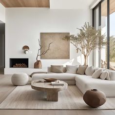 a living room filled with lots of white furniture