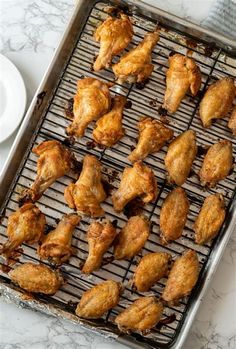 chicken wings on a baking sheet ready to be cooked in the oven for dinner time