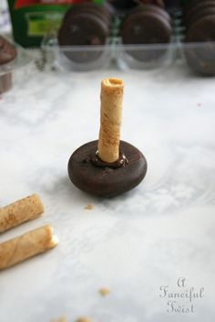 a cork is sitting on top of a table next to some chocolate covered doughnuts