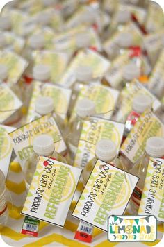 several bottles of lemonade sitting on top of a table next to each other with labels in front of them