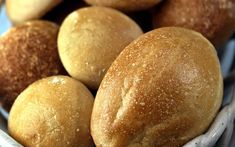 some bread rolls in a bowl on a table