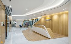 an office lobby with white marble flooring and wooden walls