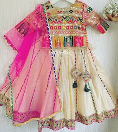 ✨ Whether your little one is attending a family wedding, or a cultural festival, or simply wants to dress up for a special occasion, the Kids Rangeela Lehenga is the perfect choice ✨ The Kids Rangeela Lehenga is a stunning and vibrant addition to any young girl's wardrobe. With its beautiful colors and intricate design, this lehenga is perfect for a wide range of occasions, from weddings to festivals and everything in between. This lehenga is versatile enough to be worn with a range of accessories, from simple jhumkas and bangles to more elaborate jewelry sets. And with its vibrant colors and intricate design, it's sure to make your child feel like a princess. ✨  The lehenga is fully lined, adding an extra layer of comfort and making it easier to wear for extended periods. The lining also Mirror Work Sharara For Wedding, White Resham Embroidery Dupatta, Traditional Dress With Gota Work For Celebration, Traditional Gota Work Dress For Celebration, Festive Multicolor Gota Work Dress, Gota Work Dresses For Celebration And Navratri, Gota Work Dresses For Navratri Celebrations, Gota Work Dresses For Celebration During Navratri, Pink Sharara With Mirror Work For Traditional Ceremonies