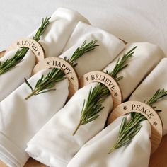 four napkins with herbs on them sitting on a table