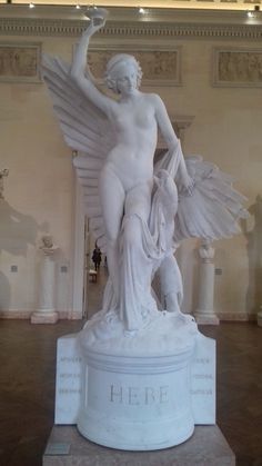 there is a white statue with wings on display