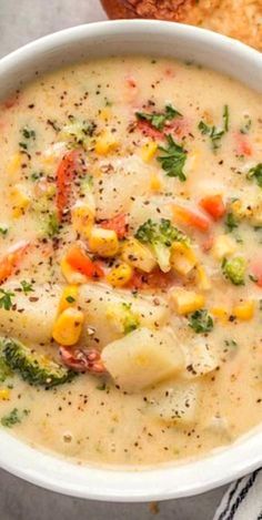 a white bowl filled with soup next to bread