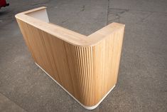 a wooden counter sitting on the side of a road