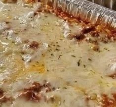 a close up of a pizza with cheese and sauce