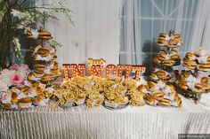 a table topped with lots of food next to a sign