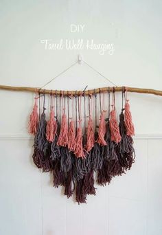 there is a wall hanging with tassels attached to it and the words diy travel will hang above it