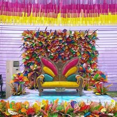 an elaborately decorated couch sits in front of colorful streamers