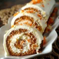 carrot roll with cream cheese frosting on a white plate