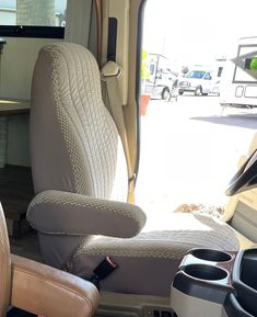 the interior of an rv with two reclining chairs and a television in the back