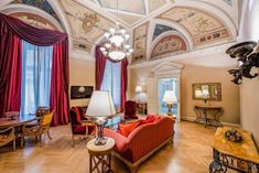 a living room filled with furniture and a chandelier