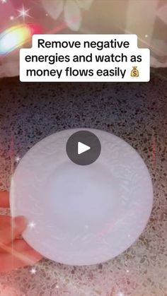 someone holding a white frisbee in their hand with the caption remove negative energy and watch as money flows easily