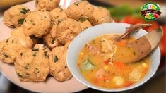 a white plate topped with meatballs next to a bowl of soup and a wooden spoon