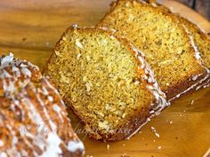 three pieces of cake sitting on top of a wooden plate