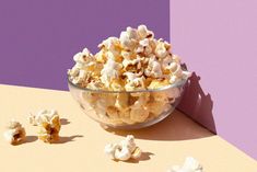 a bowl filled with popcorn sitting on top of a table