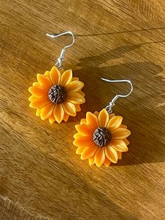 Sunflower Acrylic Drop Earrings. Includes 925 Sterling Silver ear wire fish drop. Yellow Hypoallergenic Flower-shaped Earrings, Sunflower Design Dangle Earrings As Gift, Sunflower Design Dangle Earrings For Gift, Orange Flower-shaped Adjustable Earrings, Sunflower Dangle Earrings For Summer, Sunflower Design Drop Earrings For Summer, Nickel-free Orange Flower Earrings, Adjustable Sunflower Design Dangle Jewelry, Adjustable Sunflower Dangle Jewelry