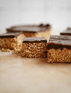 several pieces of chocolate and oatmeal dessert sitting on a counter with one slice cut out