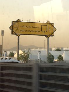 a yellow sign that is on the side of a road