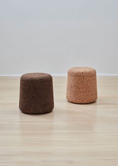 two small stools sitting on top of a hard wood floor next to each other