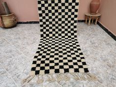 a black and white checkered rug on the floor