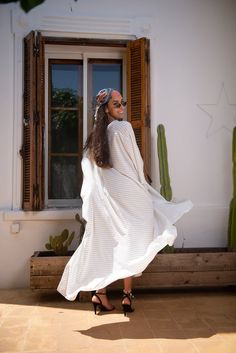 Handmade black and white stripes kaftan, designed with handmade silk pompoms. very loose and flattering to any body type.pair it with heels or flats. Must have style in any wardrobe.DETAILSViscose, linenFront Handmade Silk pompomOne size fits allThis is a very loose kaftan. The model wears SmallDry clean onlyHandmade in Morocco.Got a question!! don't hesitate to contact me :) Striped Maxi Dress For Beach Cover-up, Chic Oversized White Maxi Dress, Striped Maxi Dress For The Beach, Striped Maxi Dress With Vertical Stripes For The Beach, Beach White Maxi Dress With Vertical Stripes, Summer White Dress With Vertical Stripes, Striped Long Dress For Vacation, Long Striped Vacation Dress, Striped Long Sleeve Maxi Dress For Vacation