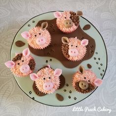 cupcakes decorated with pink frosting and brown icing are on a plate