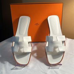 Like New Condition, Never Worn Calfskin Leather With “H” Cut-Out Color: White With Brown Stitching Made In Italy Size: 41 Minor Spots On Soles Includes Box And Dust Covers Hermes Shoes, Hermes Paris, Dust Cover, Women's Shoes Sandals, Calf Skin, Shoes Sandals, Cut Out, Outfit Ideas, Color White