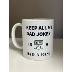 a coffee mug that says, i keep all my dad jokes in a dad - a - base