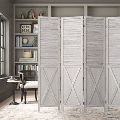 the room divider is made out of wood and has three doors on each side