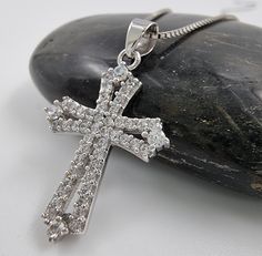 💖 Design: This beautiful Cross pendant is made from 925 Sterling Silver and adorned with sparkling Cubic Zirconia Crystal. 💖 This Catholic cross is intended to give a protection, bringing healing and positive transformation to the wearer. 💖 Authentic handcrafted piece provided directly from the Holy Land, Jerusalem. Handmade with the finest attention to detail. Blessed in the Holy Sepulcher Church. 💖 Size: Pendant: 2.5 cm (1 inch). Weight: approximately 1.8 gr This amazing pendant has protective qualities and spiritual benefits. 💖 Ideal Gift: This beautiful cross pendant comes with an elegant gift pouch and certificate of authenticity. 18 Inch Silver Box Chain Included. A perfect gift for women, men, friend, and so on. Can be used in birthday, wedding, Holidays gift, anniversary, or o Silver Cross Jewelry With Brilliant Cut, Silver Brilliant Cut Cross Pendant Jewelry, Formal Cross Necklace With Cubic Zirconia, Formal Cross Necklace In Cubic Zirconia, Formal Cubic Zirconia Cross Necklace, Silver Cubic Zirconia Cross Pendant Necklaces, Sterling Silver Cross Pendant With Pave Setting, Sterling Silver Pave Setting Cross Pendant Jewelry, Silver Cross Necklace With Brilliant Cut