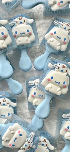 several blue and white dog shaped cookies in plastic cases