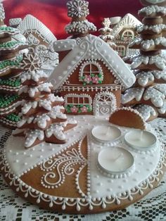 a table topped with lots of different types of gingerbreads and cookies covered in icing