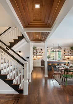 an open floor plan with wood floors and white railings