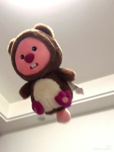 a stuffed animal is hanging from the ceiling