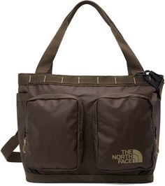 Recycled ripstop and recycled ballistic nylon canvas tote in brown. · Water-resistant non-PFC DWR-coating · Rolled shoulder straps · Adjustable and detachable crossbody strap · Webbing daisy chain at face · Logo printed at face · Zip compartments · Patch pocket at sides · Luggage strap at back face · Two-way zip closure · Mesh zip pocket at interior · Padded laptop compartment · Canvas lining · H14 x W15.5 x D5.5 / 25 L Supplier color: Brown/Khaki stone Brown Water, Face Base, Luggage Strap, Face Logo, Base Camp, Daisy Chain, Black North Face, North Face Mens, Mesh Bag