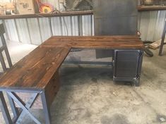 a wooden bench sitting in front of a metal workbench on top of a cement floor