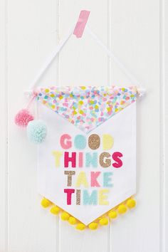 a sign hanging on the side of a white wall that says go things take time