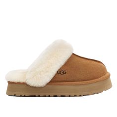 UGG Women's Disquette Slipper Features: Merging the Coquette and Disco styles for a new slipper that's completely unique, the Disquette adds a retro-style platform sole to a familiar slip-on silhouette for outdoor wear, all-day cushion, and a maximalist look. Crafted from our signature sheepskin and suede, this effortless style adds a playful statement to all your favorite outfits try pairing with jeans or a flowy midi dress. Suede upper Sheepskin collar 10mm sheepskin lining 10mm sheepskin inso Disco Style, Wool Shoes, Flowy Midi Dress, Platform Clogs, Ugg Slippers, Platform Slippers, Outdoor Wear, Retro Stil, Ciabatta