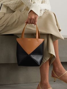 LOEWE's 'Puzzle Fold' tote has taken on many iterations, each one as memorable as the last. This version is made from panels of black and brown leather with a clever geometric design that can be folded flat. Wear it cross-body with the adjustable strap and carry your phone, keys and other daily essentials inside. The Row Bag, Loewe Puzzle, Denim Flats, Mini Convertible, Floral Dresses Short, Mini Tote, Leather Tote Bag, Blue Bags, Womens Tote Bags