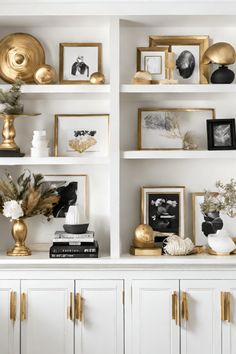 white shelves with gold accents and pictures on them