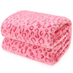 the pink leopard print flee blanket is folded on top of each other, with an animal print