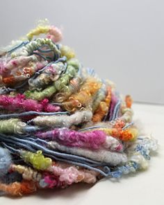 a pile of multicolored yarn sitting on top of a table