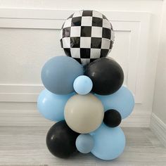 a bunch of balloons that are in the shape of a ballon and checkerboard