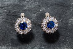 Victorian Earrings set with a Created Sapphire in a flawless clarity & brilliant royal blue color in a 7mm (3 Carats for the pair), surrounded by high grade CZ Diamonds. Vintage Earrings design made of Solid 925 Sterling Silver ☞ made to last. Matching Ring: www.etsy.com/uk/listing/467023734 Matching Pendant: www.etsy.com/uk/listing/462931841 ⌛ Last pair left ⌛    For Pierced Ears - has a pin that goes into the ear and a leaver that securely closes on the pin behind the earlobes - "English Lock" Blue Diamond Drop Earrings For Anniversary, Classic Blue Diamond Drop Earrings, Blue Diamond Earrings With Halo Design For Anniversary, Classic Blue Diamond Earrings For Wedding, Classic Sapphire Diamond Earrings For Wedding, Classic Blue Brilliant Cut Earrings, Classic Blue Diamond Earrings Brilliant Cut, Blue Diamond Round Earrings For Wedding, Classic Sapphire Earrings With Brilliant Cut